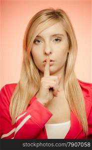 Secret woman finger on lips. Teen sporty girl showing hand silence sign, saying hush be quiet.