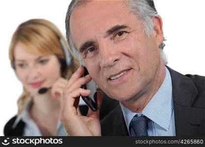 secretary and businessman working on the phone