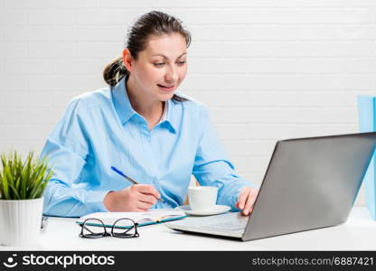 Secretary girl working in the office behind laptop