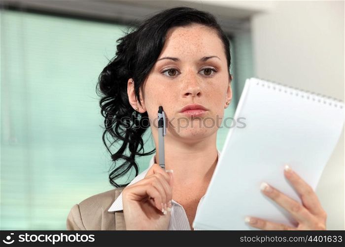 Secretary holding a notepad