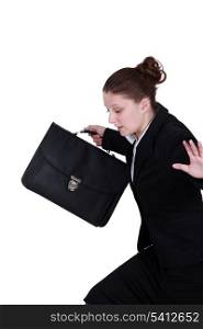 secretary holding briefcase trying to keep her balance