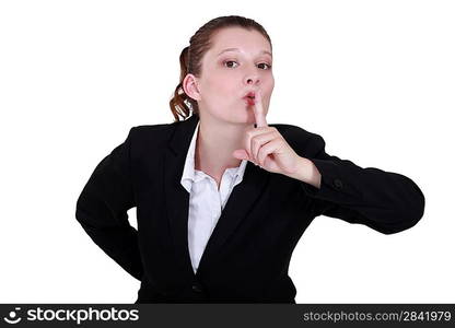 secretary with finger before her mouth