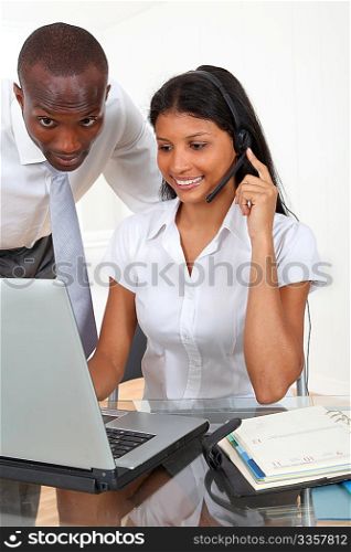 Secretary with manager working in office