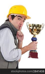 Secretive construction worker with a trophy