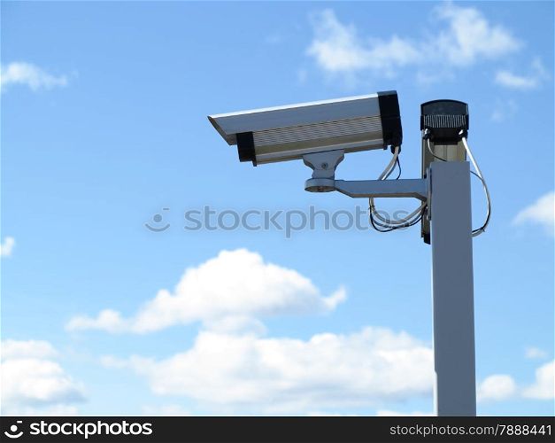 Security camera CCTV video surveillance over blue sky