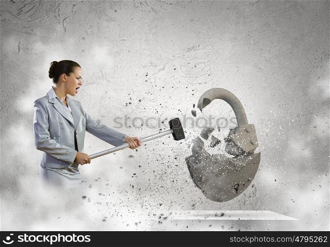 Security concept. Image of businesswoman crashing lock with hammer