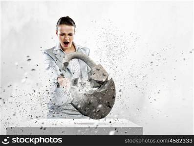 Security concept. Image of businesswoman crashing lock with hand