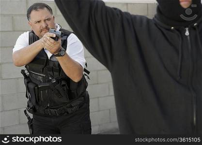 Security guard aiming gun at thief