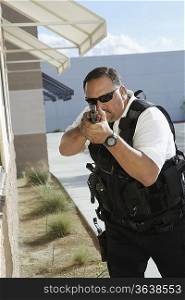 Security guard aiming with gun outdoors