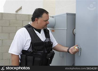 Security guard checking padlock