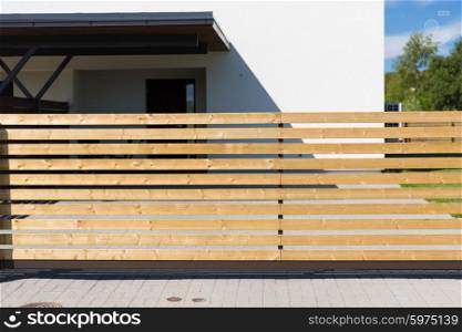 security, real estate and home concept - close up of rail fence in front of private living house