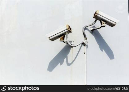 Security surveillance cameras on white wall. Private property protection. CCTV camera.