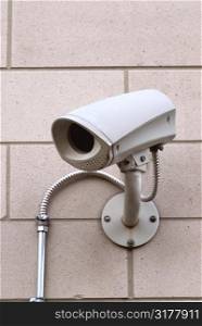 Security video camera on outside wall of a building