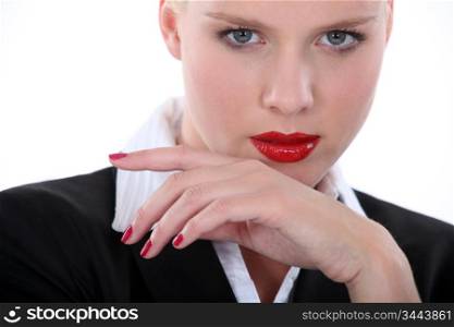 Seductive blond wearing red lip-stick and nail varnish