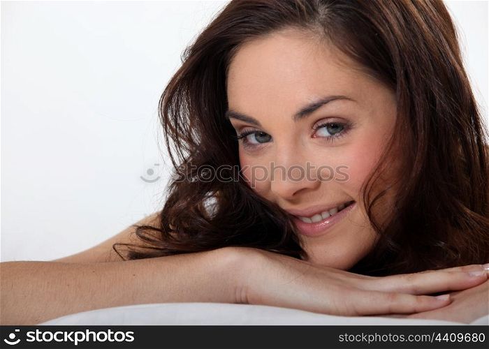 Seductive brunette laying in bed