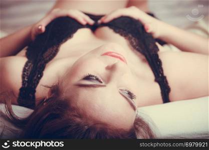 Seductive sexy gorgeous woman wearing lingerie in bed at home. Attractive sensual young girl with long hair. Female underwear fashion.. Seductive young woman in lingerie in bed.