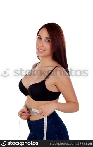 Seductive woman with black bra measuring her waist with a tape measure