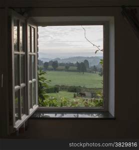 see through window with garden horses and hills