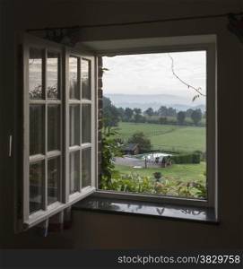 see through window with landscape and hills of belgium as background