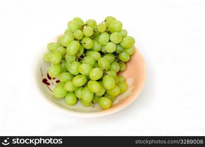 Seedless grapes in a ceramic bowl isolated on a white background. Green Grapes In A Bowl