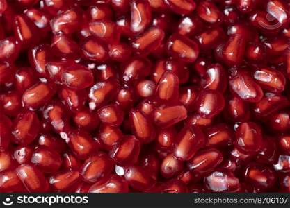 Seeds of ripe red pomegranate as background. Close up view.