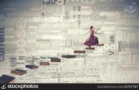 Seek for education and knowledge. Woman in long dress with book in hand