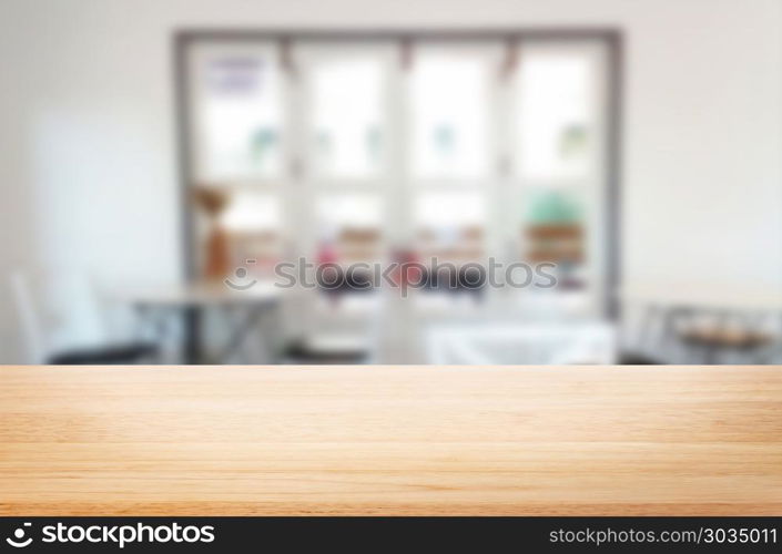 Selected focus empty brown wooden table and Coffee shop blur bac. Selected focus empty brown wooden table and Coffee shop blur background with bokeh image. for your photomontage or product display.