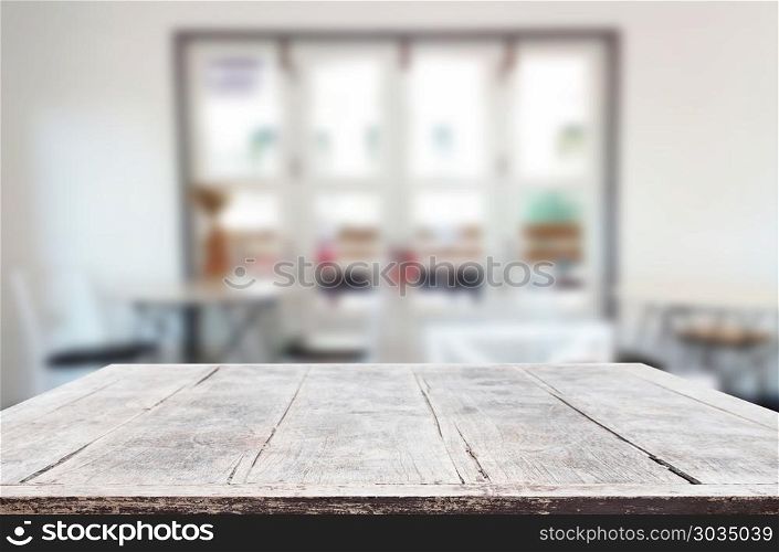 Selected focus empty brown wooden table and Coffee shop blur bac. Selected focus empty brown wooden table and Coffee shop blur background with bokeh image. for your photomontage or product display.