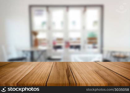 Selected focus empty brown wooden table and Coffee shop blur bac. Selected focus empty brown wooden table and Coffee shop blur background with bokeh image. for your photomontage or product display.