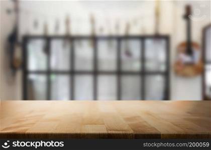 Selected focus empty brown wooden table and Coffee shop or restaurent blur background with bokeh image. for your photomontage or product display