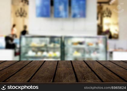 Selected focus empty brown wooden table and Coffee shop or restaurent blur background with bokeh image. for your photomontage or product display.