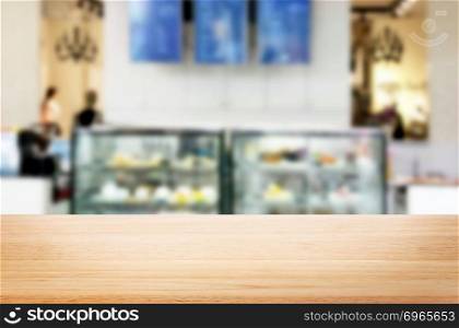 Selected focus empty brown wooden table and Coffee shop or restaurent blur background with bokeh image. for your photomontage or product display.