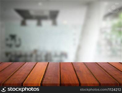 Selected focus empty brown wooden table and meeting room or office work blur background image. for your photomontage or product display