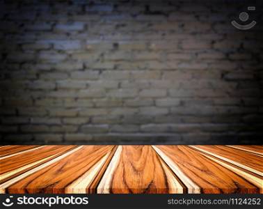 Selected focus empty brown wooden table and wall texture or old black brick wall blur background image. for your photomontage or product display.