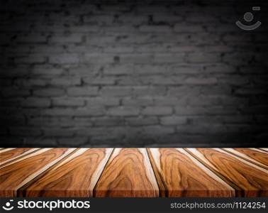 Selected focus empty brown wooden table and wall texture or old black brick wall blur background image. for your photomontage or product display.