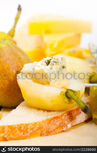 selection of different cheese and fresh pears appetizer snack 