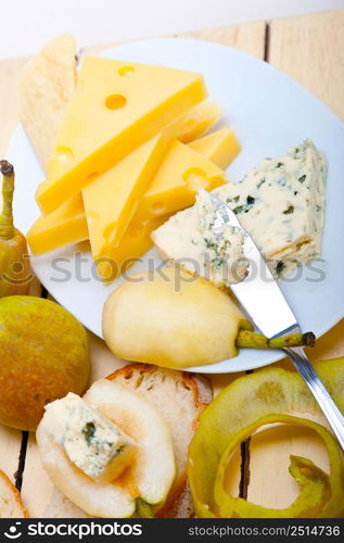 selection of different cheese and fresh pears appetizer snack