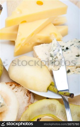 selection of different cheese and fresh pears appetizer snack