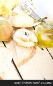 selection of different cheese and fresh pears appetizer snack