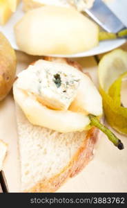 selection of different cheese and fresh pears appetizer snack