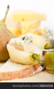 selection of different cheese and fresh pears appetizer snack