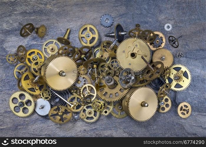 Selection of dusty old brass clock parts.
