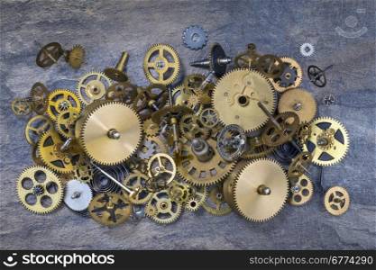 Selection of dusty old brass clock parts.