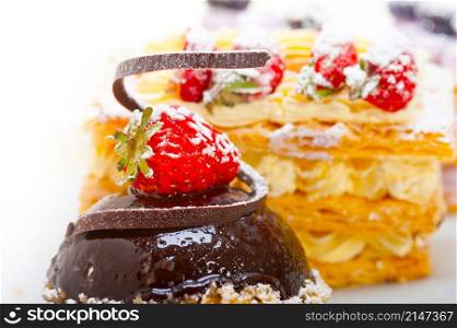 selection of fresh cream napoleon and chocolate mousse cake dessert plate