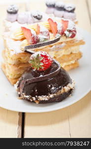 selection of fresh cream napoleon and chocolate mousse cake dessert plate