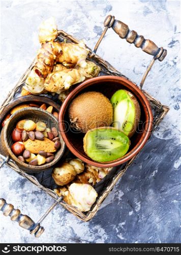 Selection of healthy food. Healthy food concept with with Jerusalem artichoke, kiwi and nuts.Clean eating