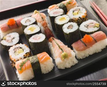 Selection of Seafood and Vegetable Sushi on a Tray with chopsticks