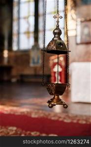 selective focus. A priest&rsquo;s censer hangs on an old wall in the Orthodox Church. Copper incense with burning coal inside. Service in the concept of the Orthodox Church. Adoration.. selective focus. A priest&rsquo;s censer hangs on an old wall in the Orthodox Church. Copper incense with burning coal inside. Service in the concept of the Orthodox Church. Adoration