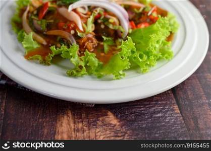 Selective focus and close up Spicy salad of sardine in tomato sauce mixed with herb on top and empty space for insert text