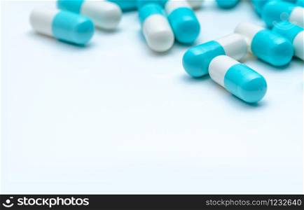 Selective focus antibiotic capsule pills on white background. Antibiotic drug resistance concept. Pharmaceutical industry. Antimicrobial medication for treatment infection. Medical healthcare.